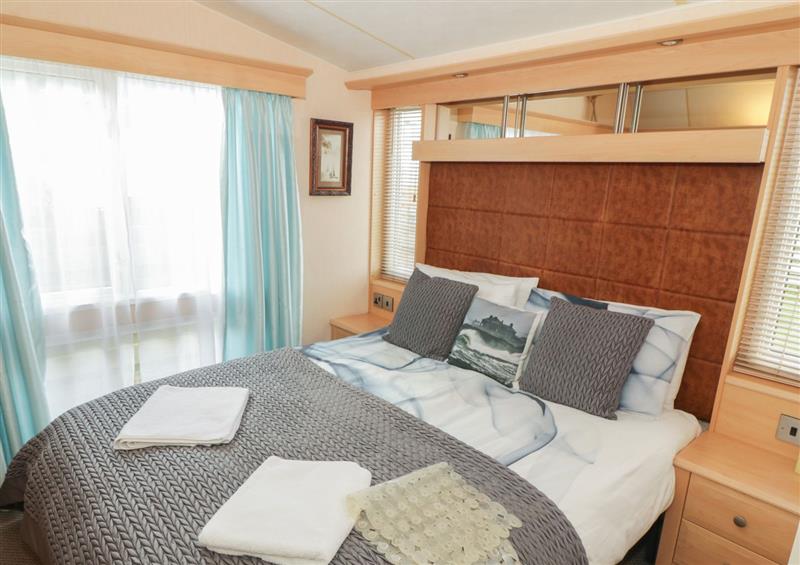 A bedroom in Coed Llai Lodge at Coed Llai Lodge, Trearddur Bay