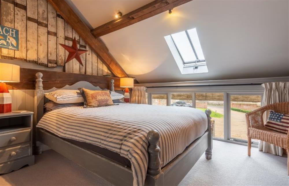 First floor: Bedroom two with double bed at Cog Cottage, Great Walsingham