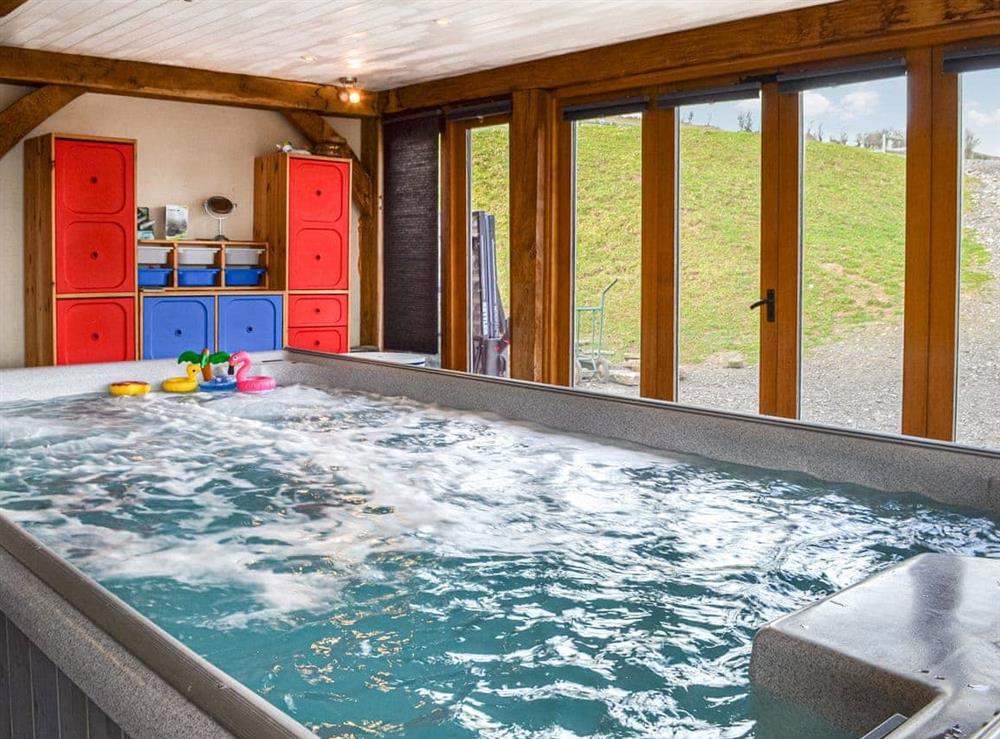 Supersize indoor hot tub within the living area at Ty Nofio, 