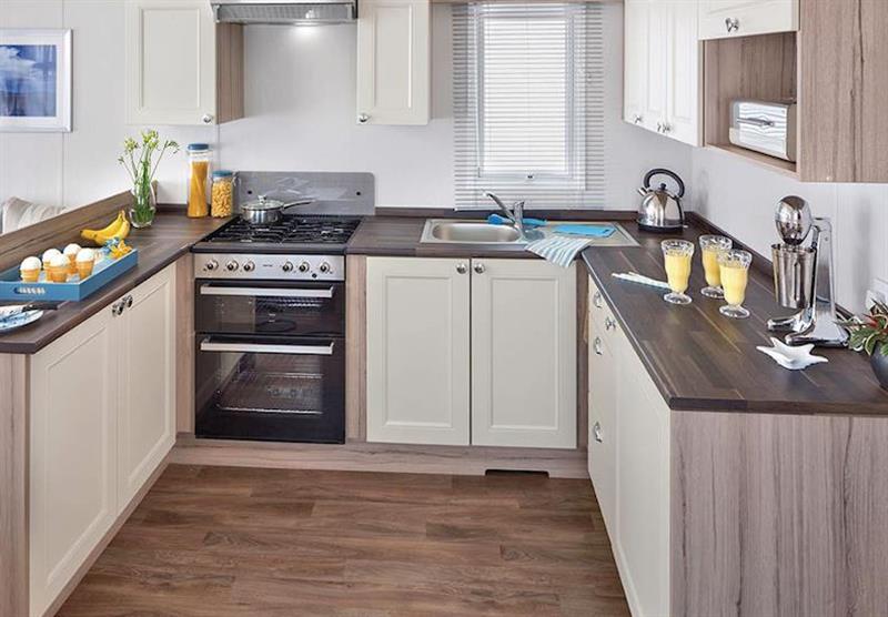 The kitchen in a Deluxe Caravan 2 at Coldingham Bay Leisure Park in Coldingham, Berwickshire