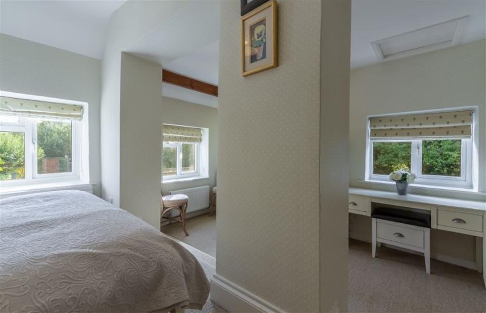 First floor: Master bedroom has dressing area and en-suite bathroom at Columbine Cottage, Holme-next-the-Sea near Hunstanton