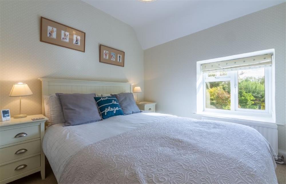 First floor: Master bedroom has king-size bed at Columbine Cottage, Holme-next-the-Sea near Hunstanton