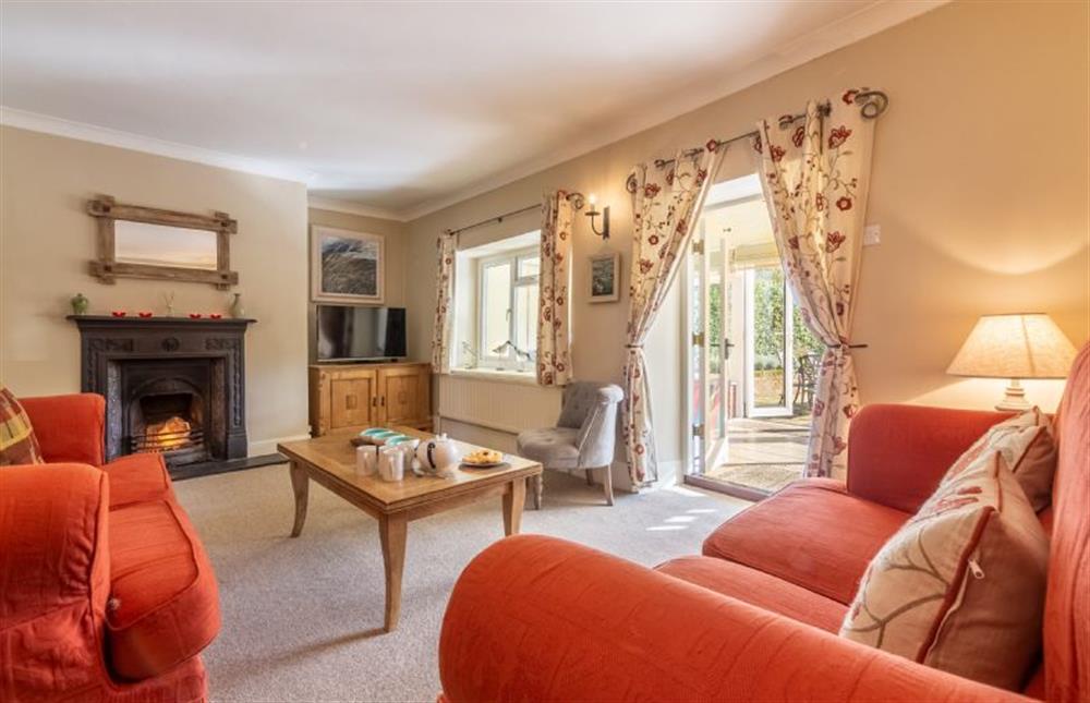 Ground floor: The sitting room has an open fire at Columbine Cottage, Holme-next-the-Sea near Hunstanton