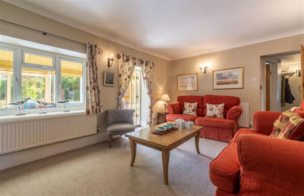 Ground floor: The sitting room opens into the conservatory at Columbine Cottage, Holme-next-the-Sea near Hunstanton
