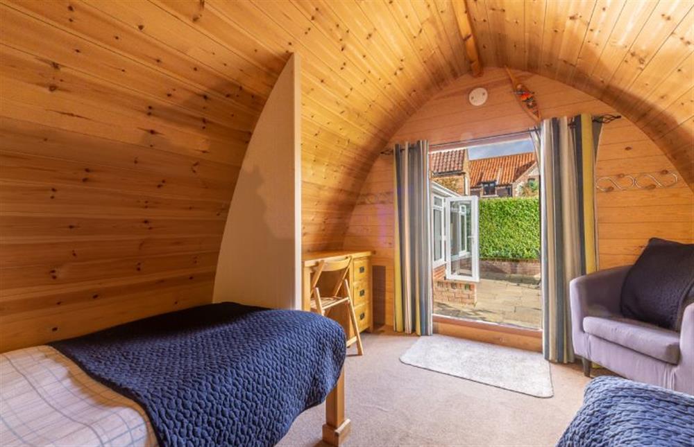 The pod is near the house and conservatory at Columbine Cottage, Holme-next-the-Sea near Hunstanton
