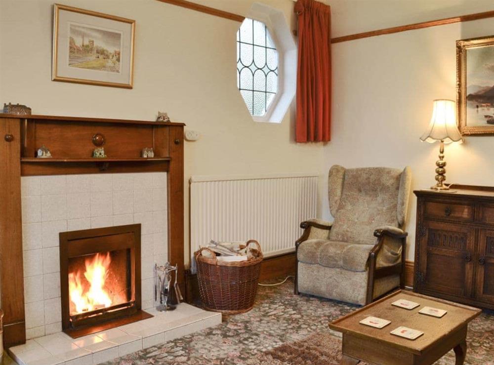 Living room with cosy open fire at Colville House in Helmsley, North Yorkshire