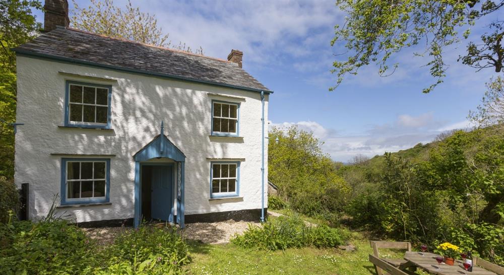 The shaded exterior of Combe Cottage, Devon