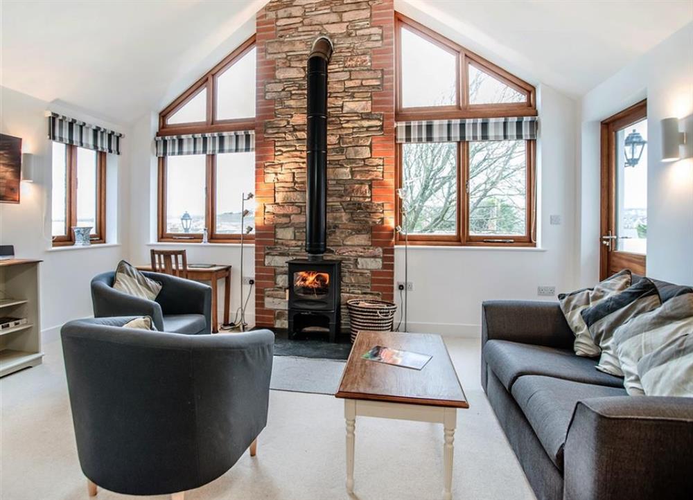 Lounge area with fireplace at Combermere Cottage in Bude