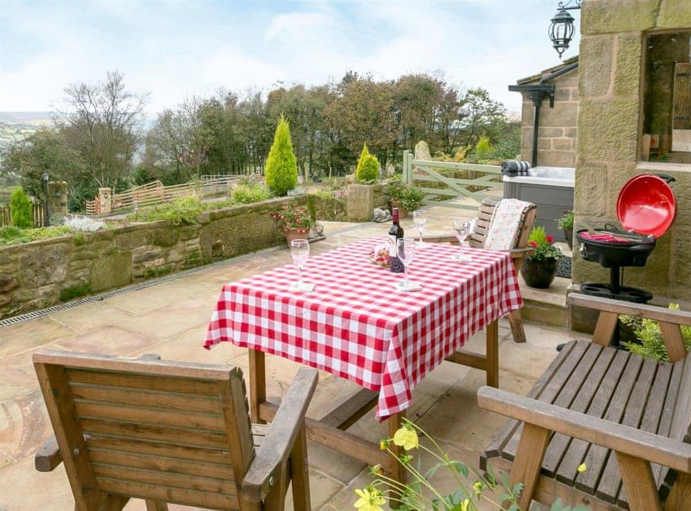 Attractive patio area with sitting out area at Commons Farm Cottage in Wadsworth, near Hebden Bridge, West Yorkshire