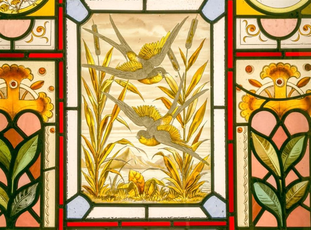 Detailed stained glass window in living room at Commons Farm Cottage in Wadsworth, near Hebden Bridge, West Yorkshire