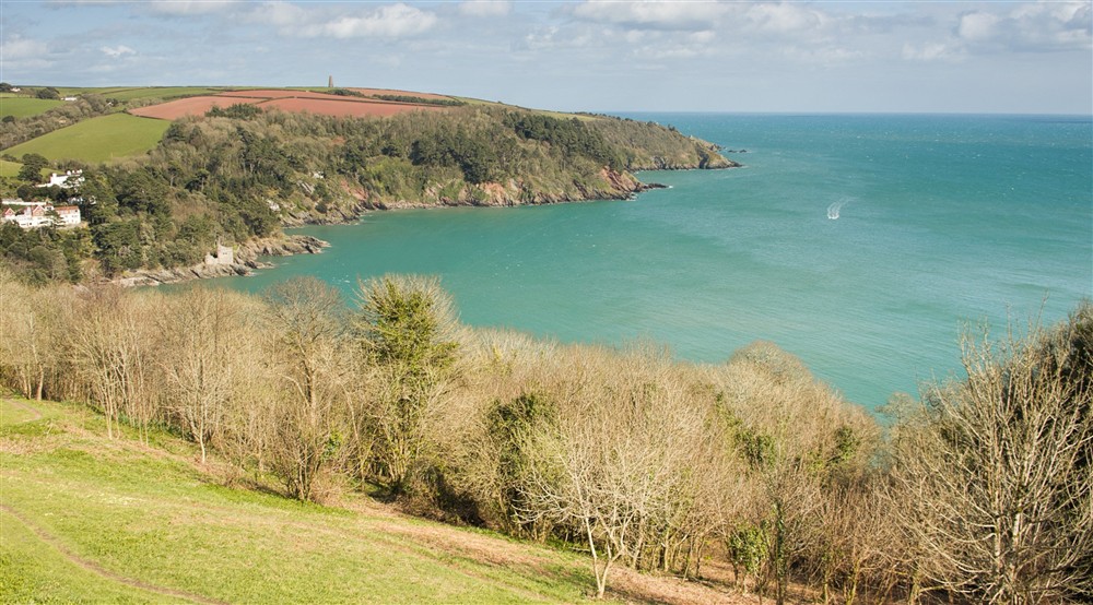 A view of the Daymark (a stone tower on the other side of the Dart estuary) on Froward Point from Gallants Bower at Compass Cottage in Dartmouth, Devon