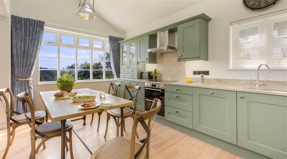 The open-plan kitchen and dining room at Compass Cottage in Dartmouth, Devon