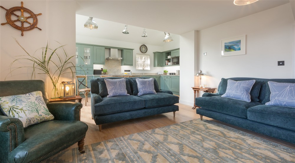The open-plan kitchen, dining and sitting room at Compass Cottage in Dartmouth, Devon