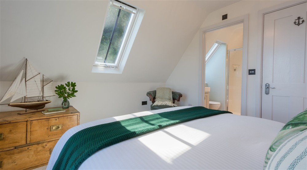 The second-floor double bedroom and entrance to the en-suite shower room at Compass Cottage in Dartmouth, Devon