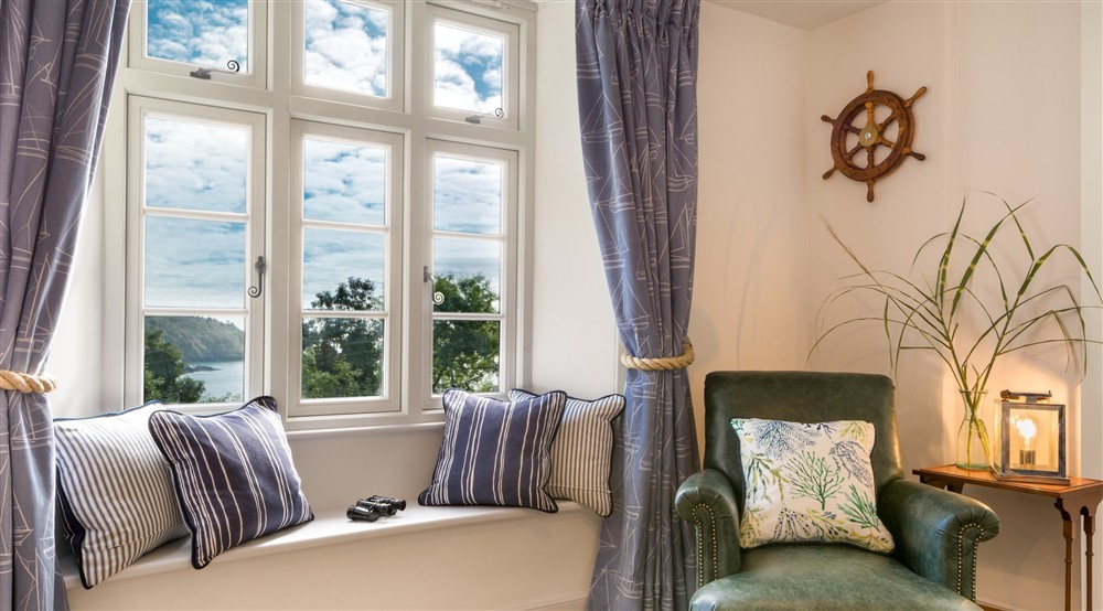 The sitting room window, with views of the Dart Estuary at Compass Cottage in Dartmouth, Devon