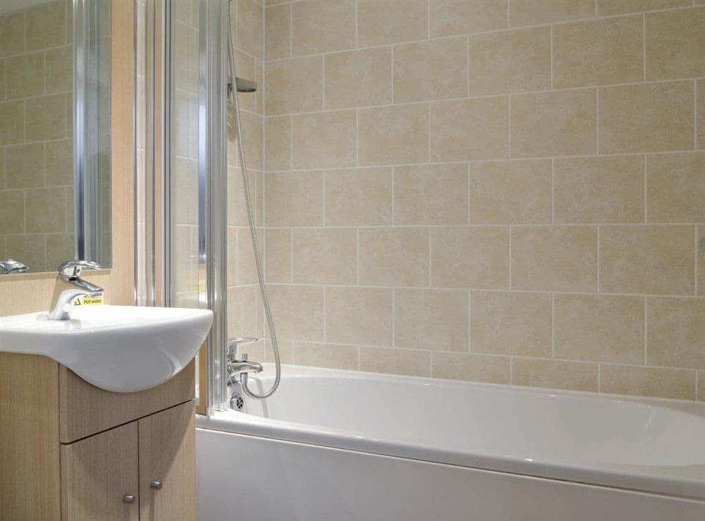 Bathroom with shower over bath at Coniston 5 in Troutbeck Bridge, near Windermere, Cumbria