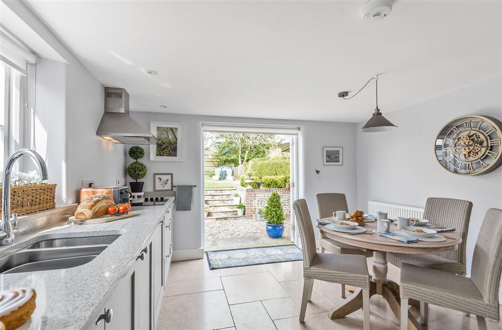 Kitchen dining area and view to the garden at Coombe Cottage, Dorchester