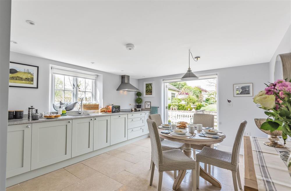 Well-equipped kitchen with dining area and french doors to garden at Coombe Cottage, Dorchester