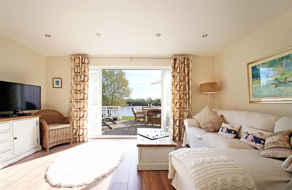 Living room with patio doors at Coot Lake House, Cotswold Lakes, Gloucestershire