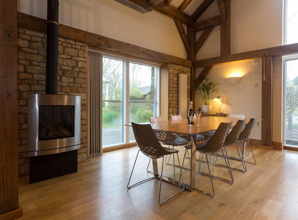 Dining area with wood burner at Coot Lodge in Somerford Keynes, near Cirencester, Gloucestershire