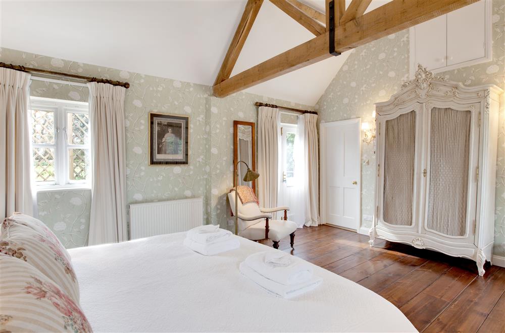 The bedroom leads out onto the west terrace at Cope Cottage, Bruern, near Chipping Norton
