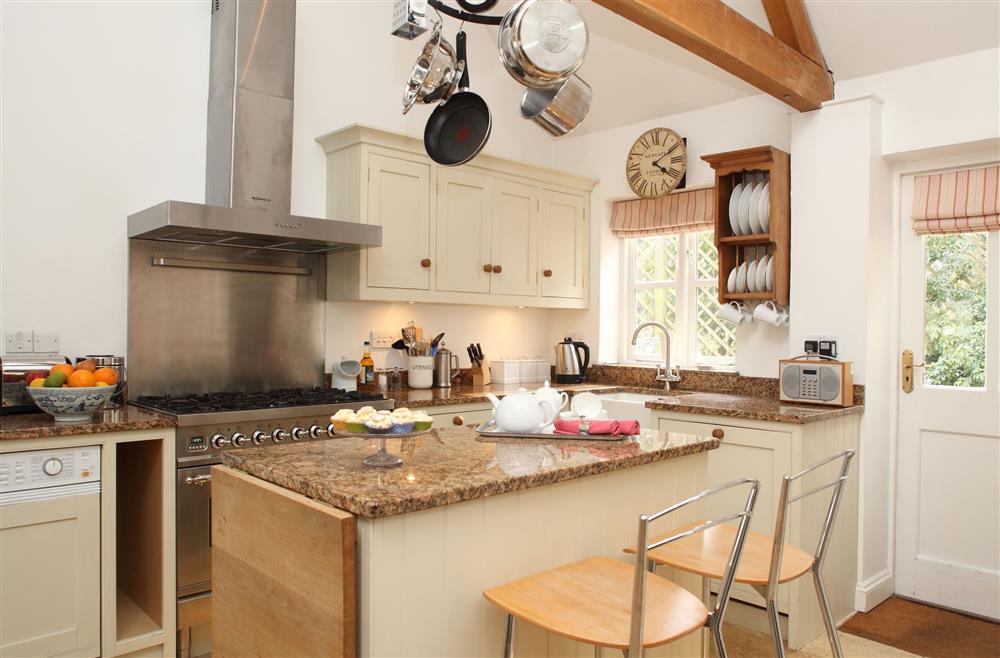 The well-equipped kitchen leads out onto the west terrace at Cope Cottage, Bruern, near Chipping Norton