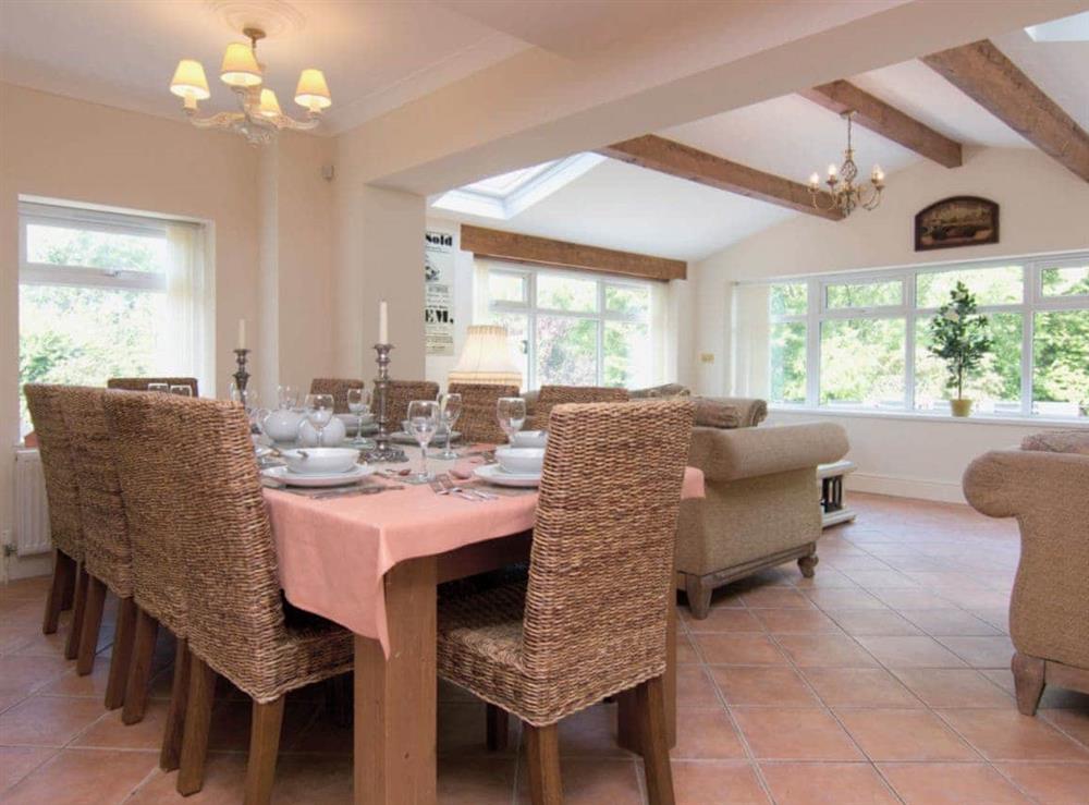 The spacious dining room adjoins a pleasant sitting area at Copper Beech Cottage  in Aberaeron, Ceredigion., Dyfed
