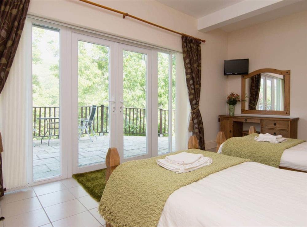 Twin bedroom in the annexe with french doors at Copper Beech Cottage  in Aberaeron, Ceredigion., Dyfed