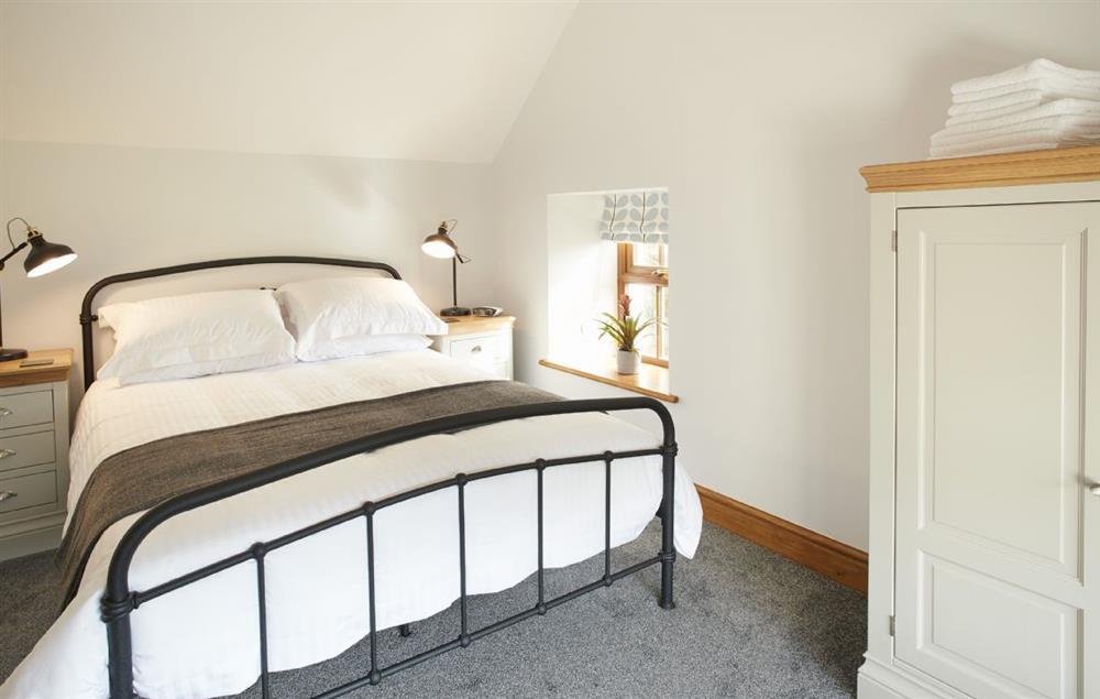 Bedroom with 5’ king-size bed at Coppet Hall Lodge, Saundersfoot