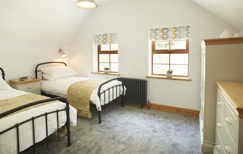 bedroom with twin 3’ single beds and en-suite shower room at Coppet Hall Lodge, Saundersfoot