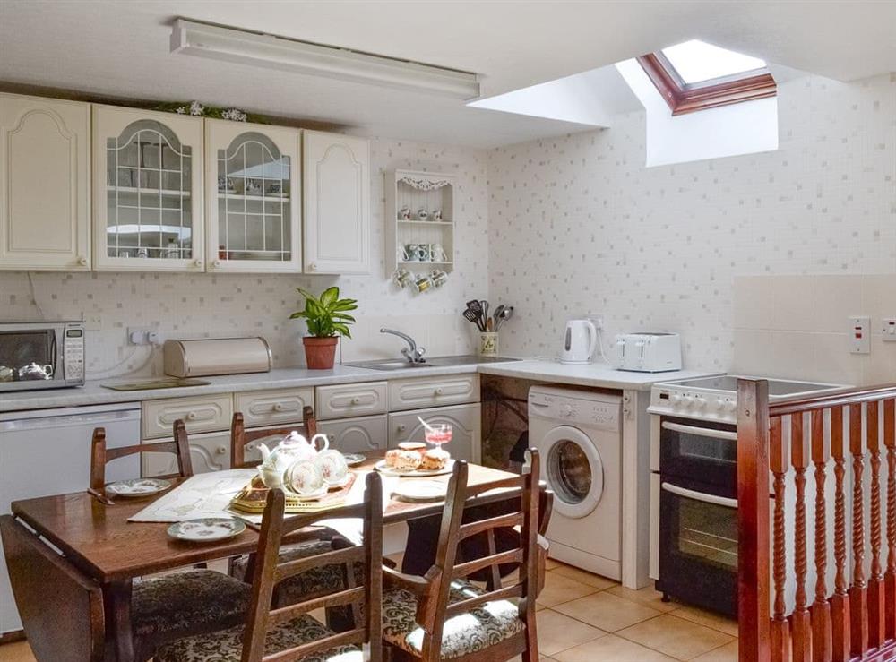 Well-equipped fitted kitchen with dining area at Low Cordorcan, 