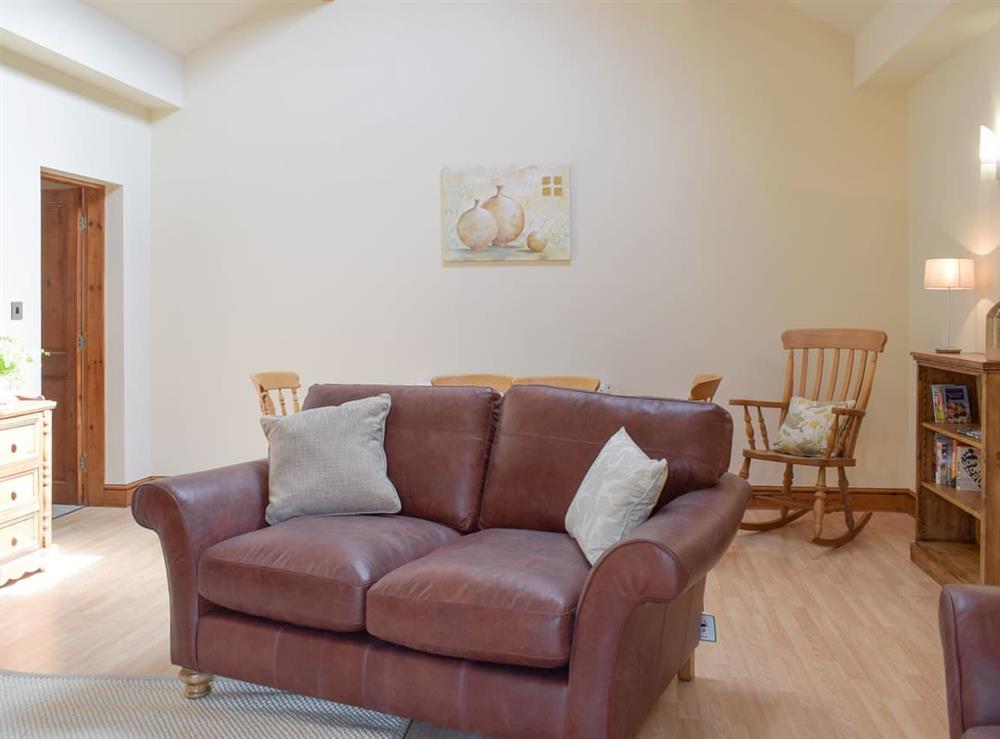 Spacious living and dining room at Woodpecker Cottage, 