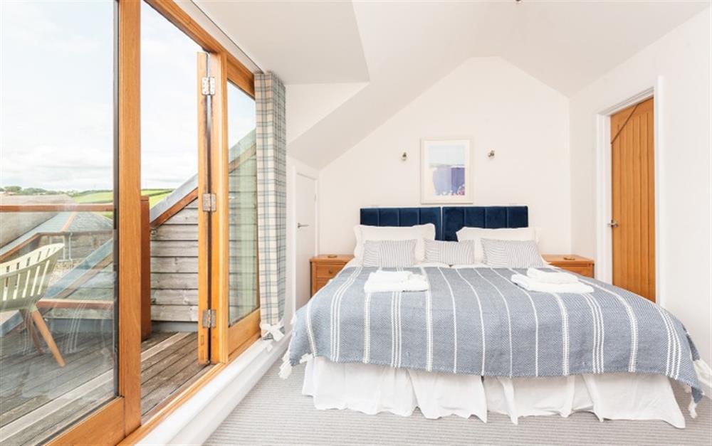 Bedroom 3 with twin 3ft beds and door to balcony at Cormorant in Dartmouth