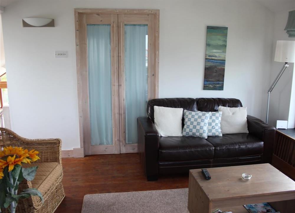 Sitting room facing double bedroom doors at Cormorants in Polruan