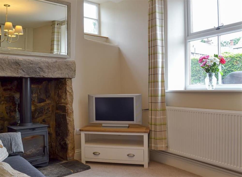 Cosy living room with wood burner (photo 2) at Corner Cottage in Great Longstone, near Bakewell, Derbyshire