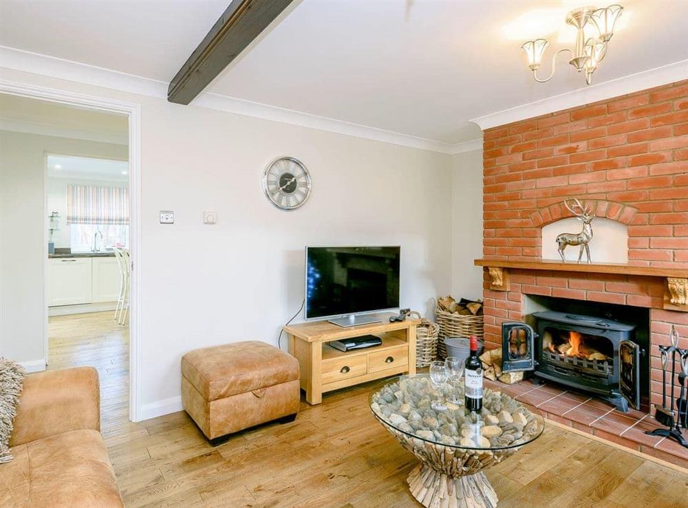 Beautifully presented living room with wood burner (photo 3) at Corner House in East Runton, Norfolk