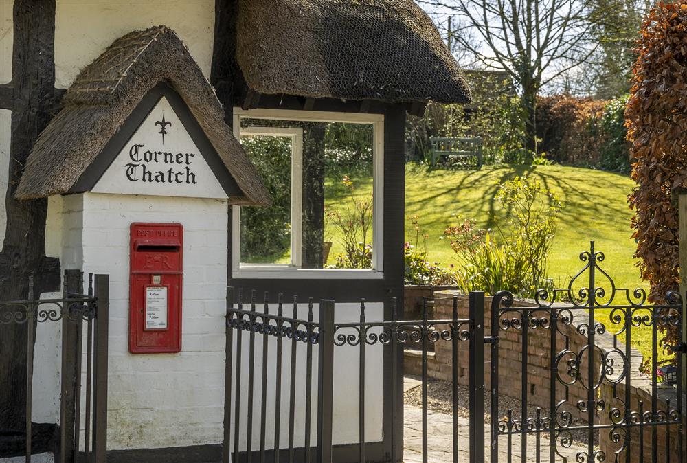 An unusual thatched post box still adorns the front of the property at Corner Thatch, Abbots Morton