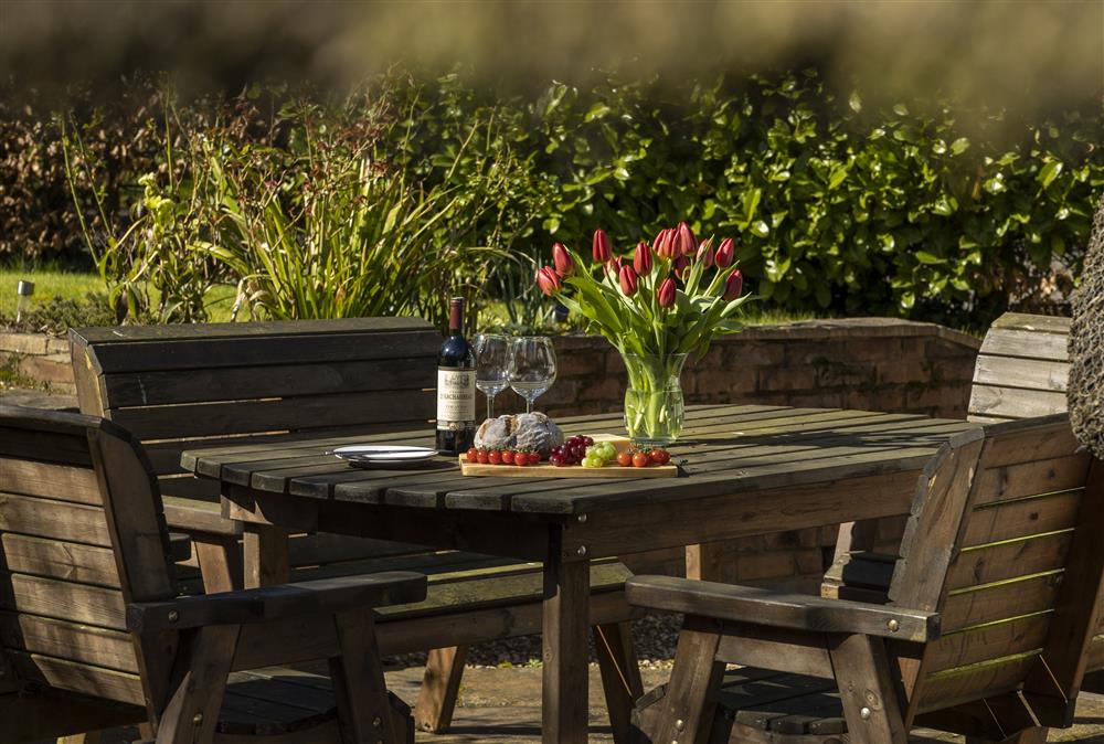 Enjoy the pretty gardens from the patio area at Corner Thatch, Abbots Morton