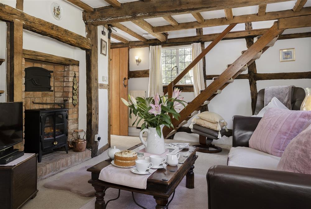 Sitting room with stairs to the first floor at Corner Thatch, Abbots Morton