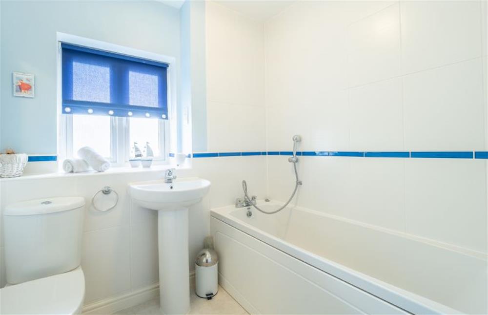 Family bathroom with bath and hand held shower, wash basin and WC at Cornish Fun, Duporth