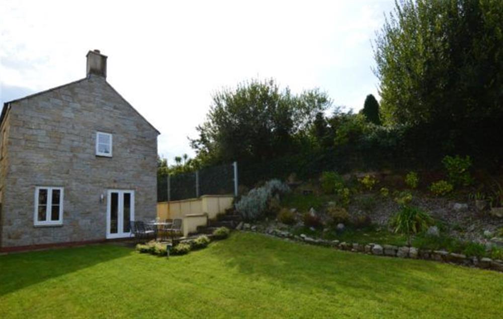Large, enclosed garden with lawn and sunny patio with barbecue at Cornish Fun, Duporth