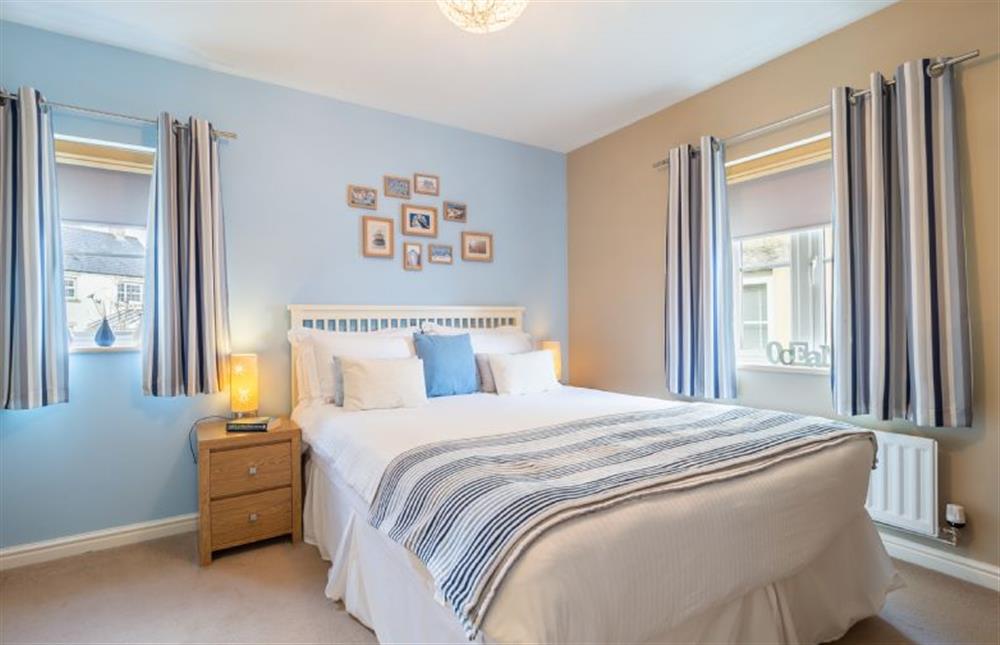 Master bedroom with a 5’ king-sized bed, television and en-suite shower room at Cornish Fun, Duporth
