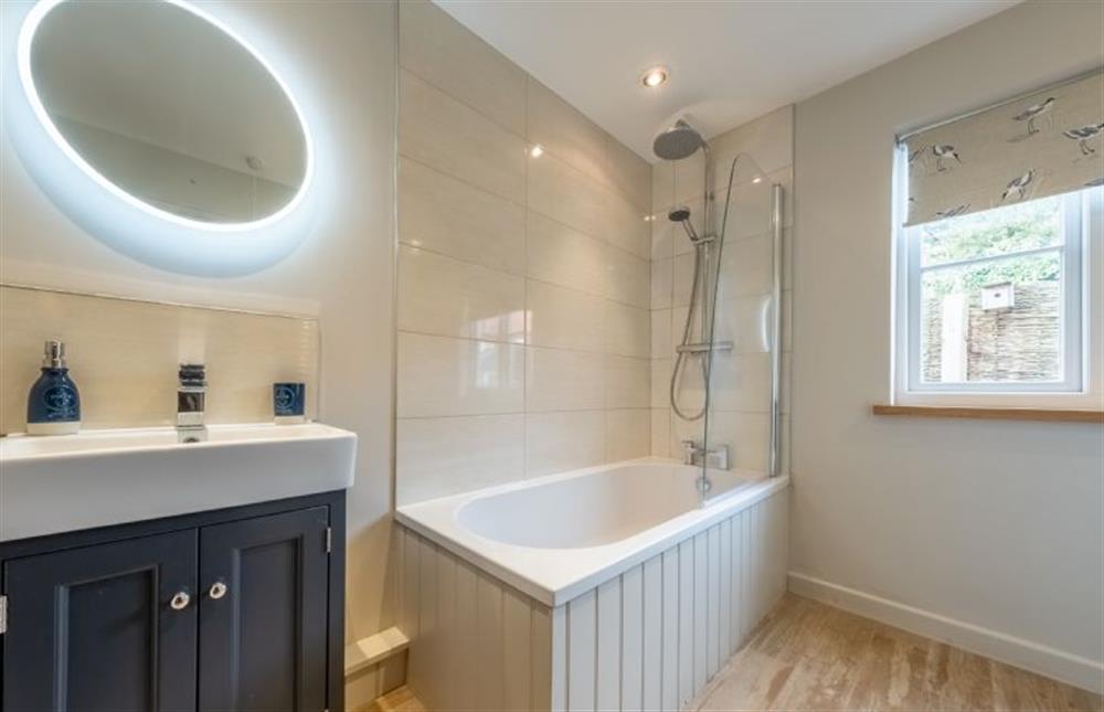 Bathroom with bath with overhead shower at Cornloft Cottage, South Creake near Fakenham
