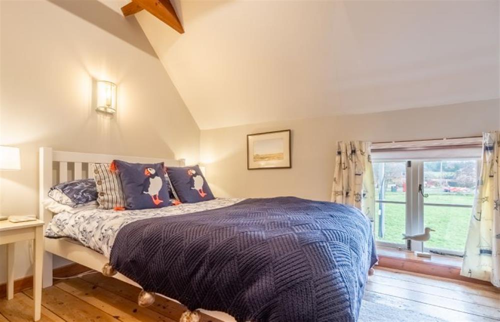 The master bedroom overlooks the village green at Cornloft Cottage, South Creake near Fakenham