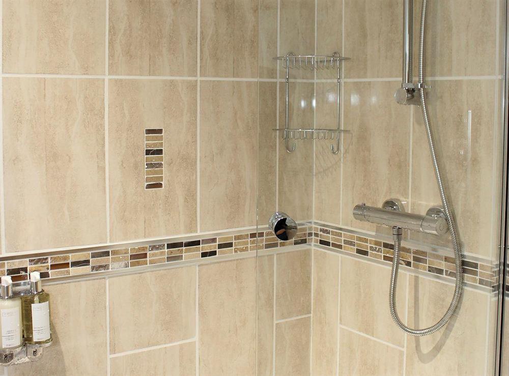 En-suite with shower over a ’P’ shaped bath
