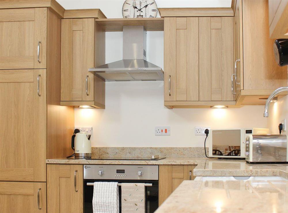 Well fitted and equipped kitchen area at The Old Barn, 