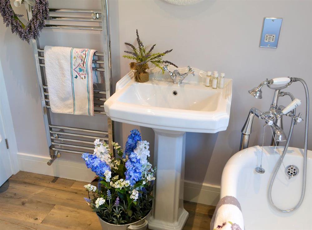 Bathroom with relaxing roll top bath (photo 3) at Cosy Cottage at the Conifers in Amble, Northumberland