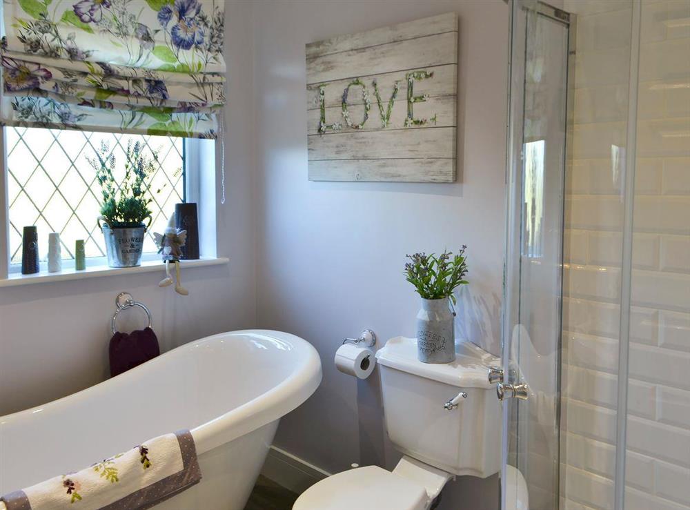 Bathroom with relaxing roll top bath at Cosy Cottage at the Conifers in Amble, Northumberland