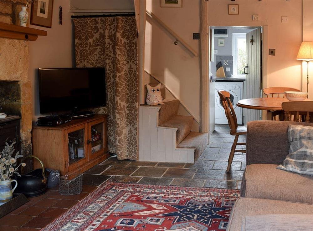 Living room with dining area at Cosy Cottage in Bourton-on-the-Hill, near Moreton-in-Marsh, Gloucestershire