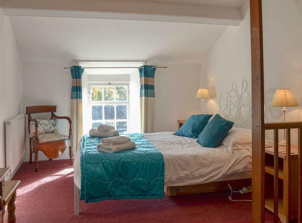 Comfortable bedroom with a double and single bed at Cosy Nook in Ambleside, Cumbria